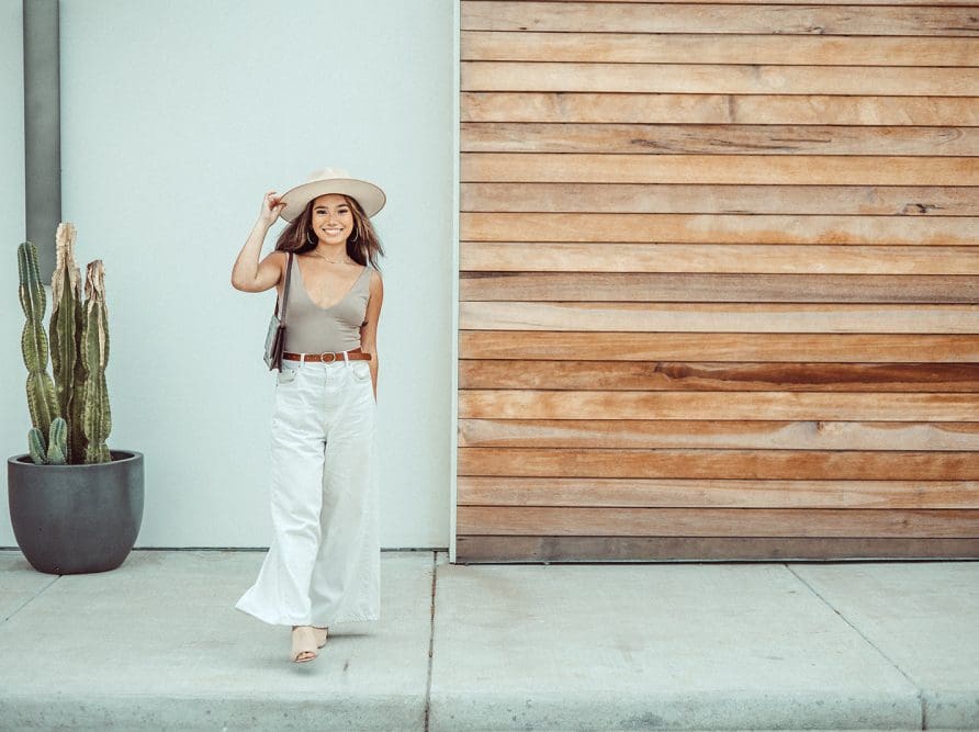 A UT student enjoys the desert-modern style of a new building near West Campus