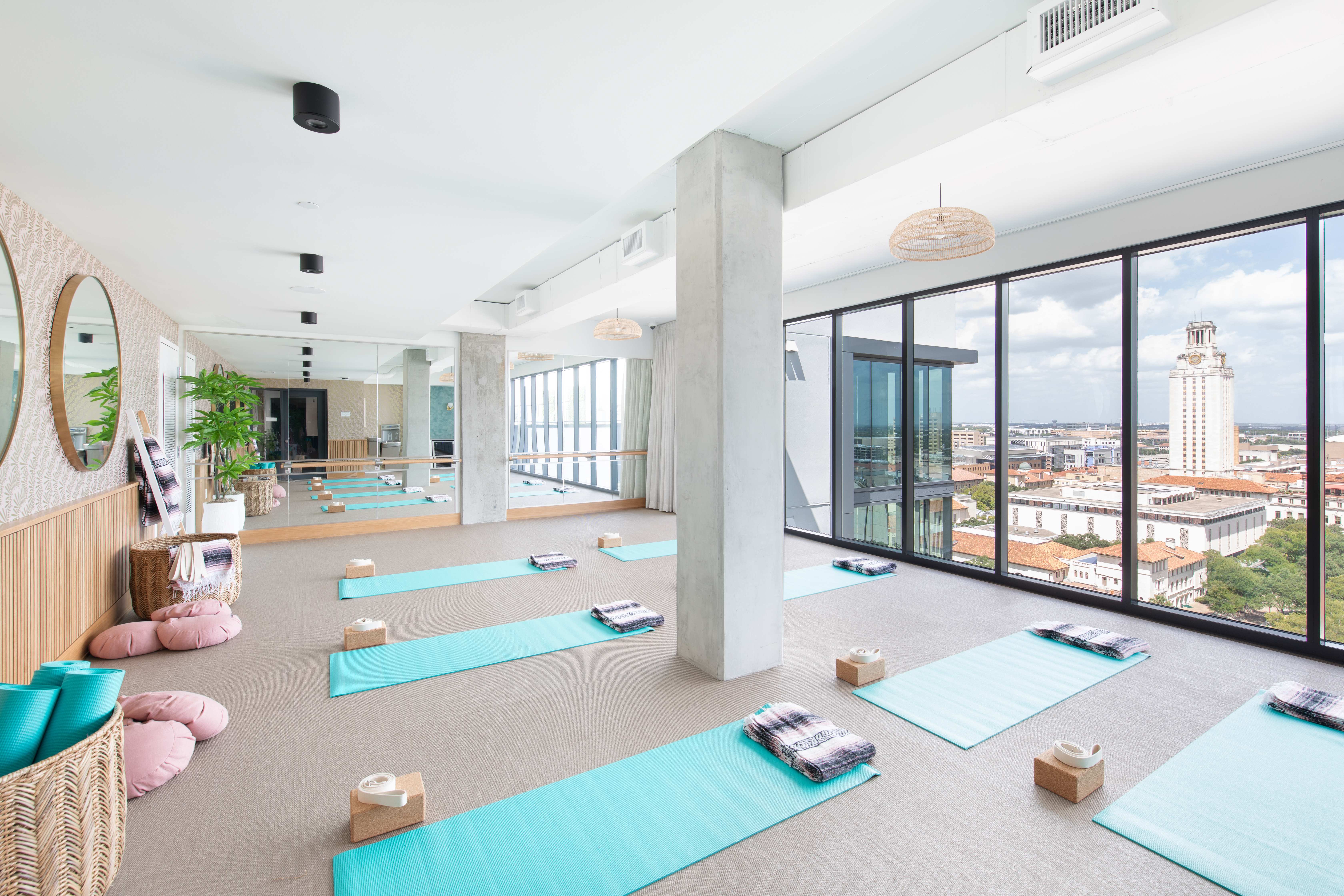 Moontower's 18th-floor yoga room overlooks the UT Austin tower and campus.