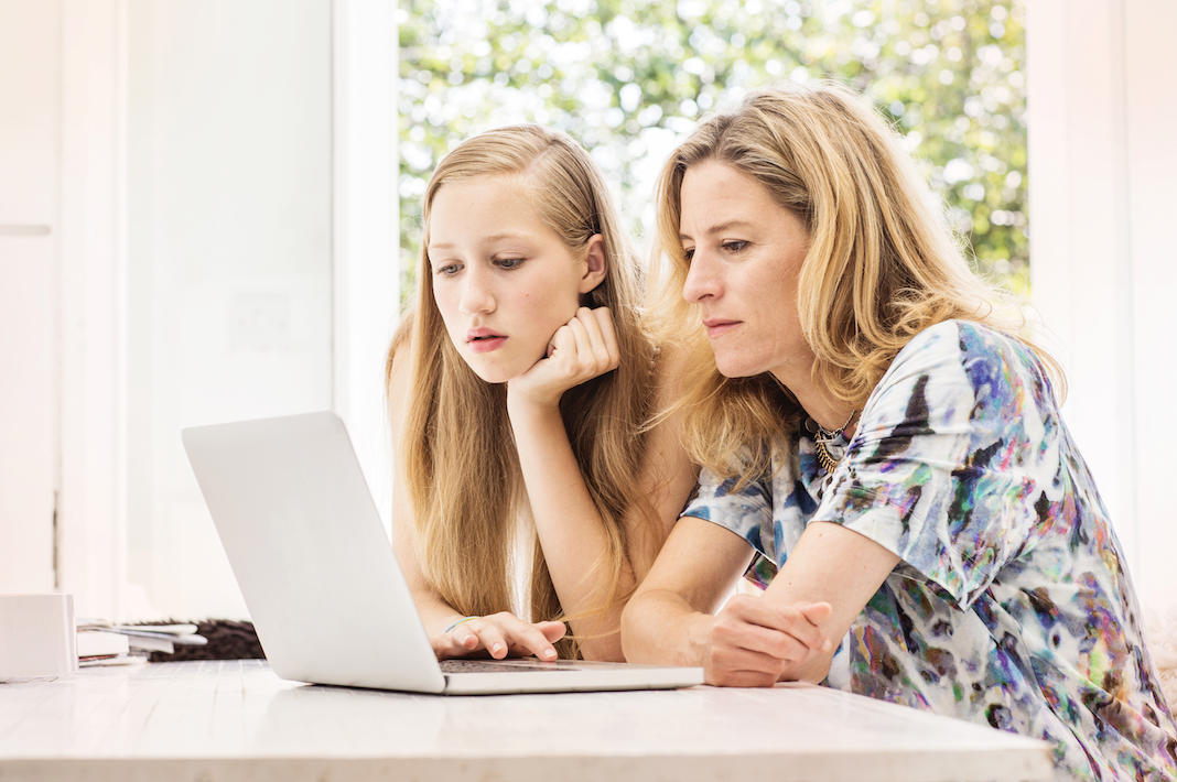 Mother and daughter using laptop.