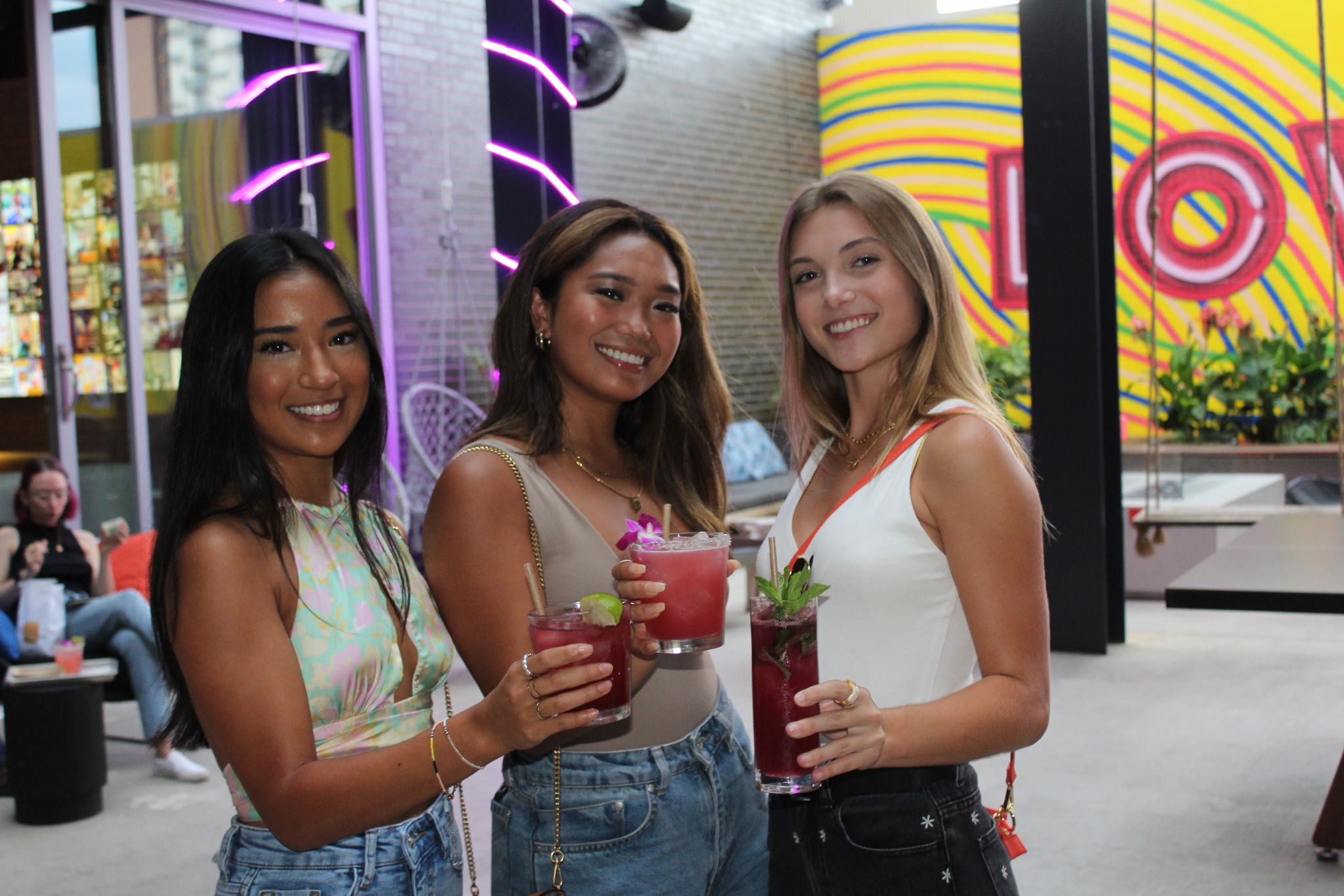 Girls with cocktails at Bar Moxy in West Campus Austin.