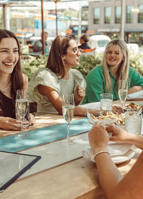 Girls talking and laughing at lunch.