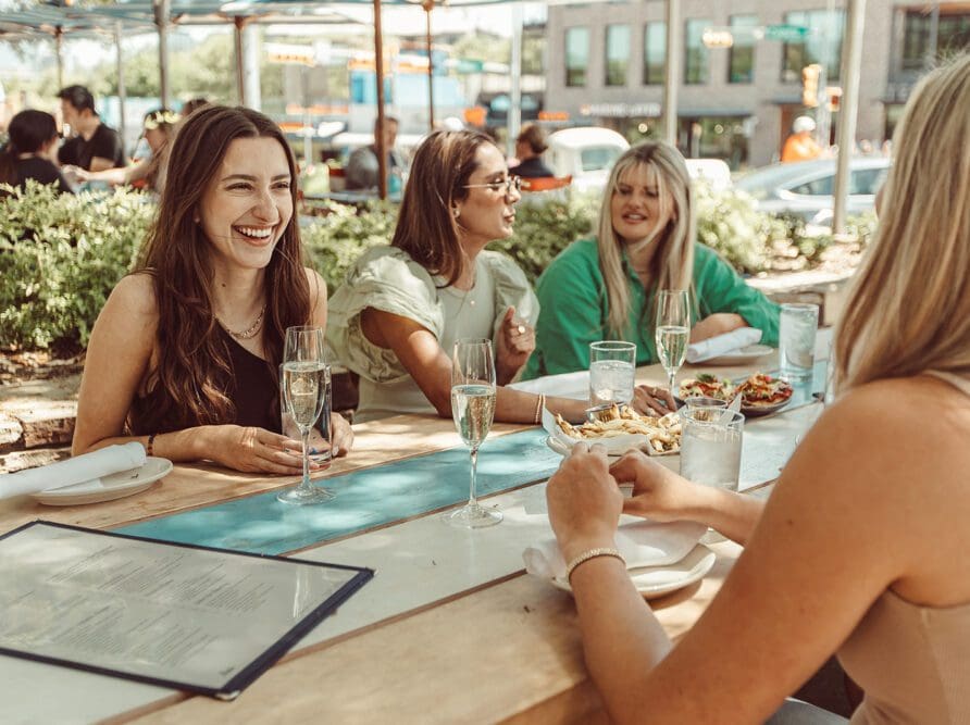 Girls talking and laughing at lunch.