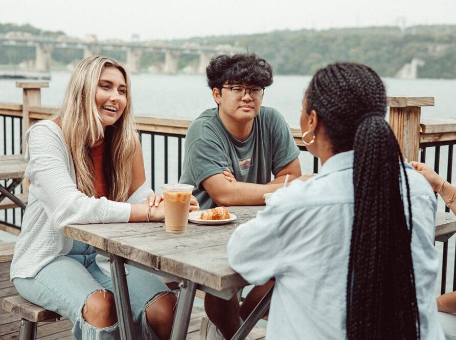 Friends talking at Mozart's Coffee Roasters in Austin.