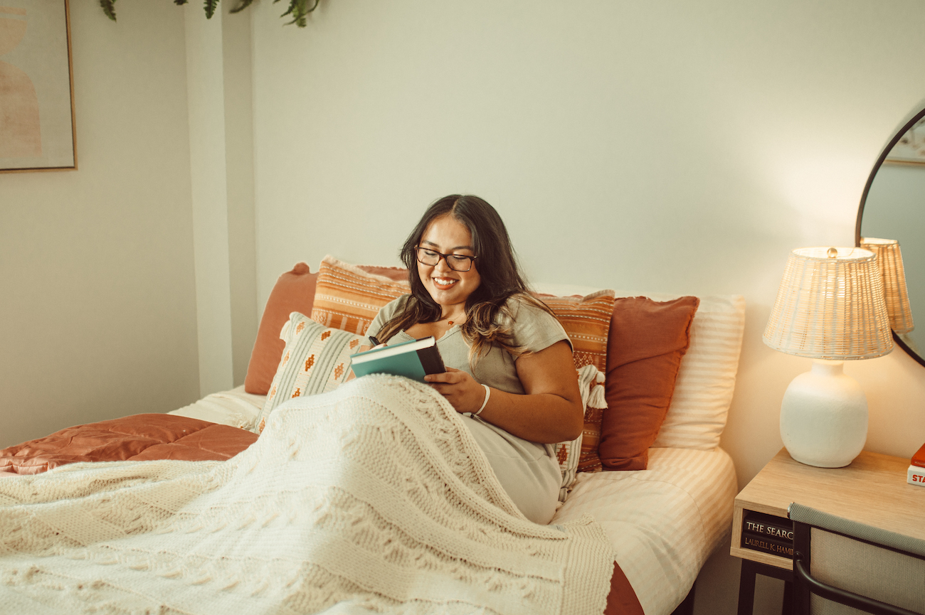 girl reading in bed