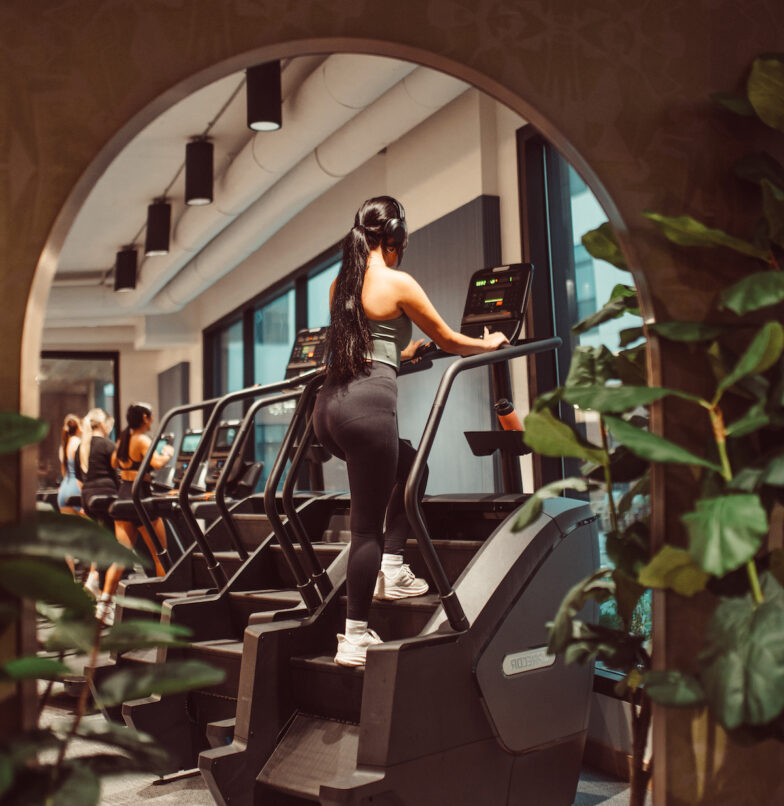 Girl on stairmaster at two-story gym at Rambler ATX