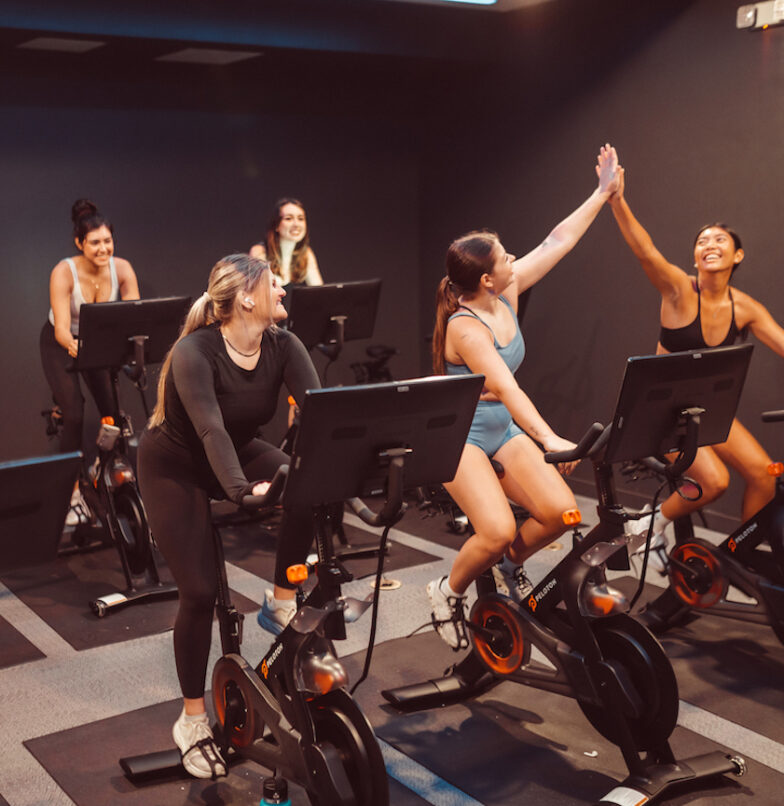 Residents doing cycling class in spin studio at Rambler