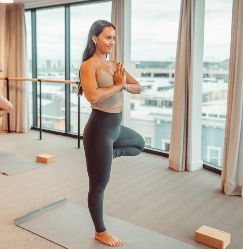 Resident in tree pose in yoga studio at Rambler in Austin, TX