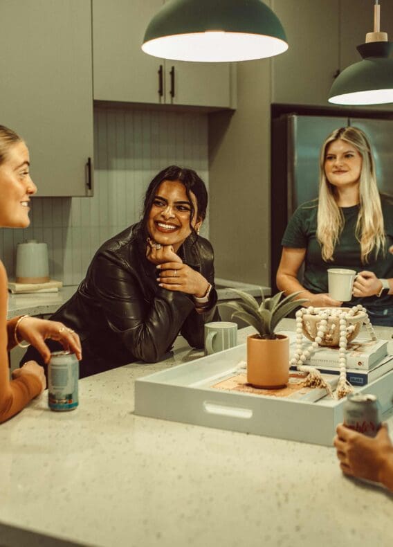 4 girls around the kitchen counter Rambler Austin